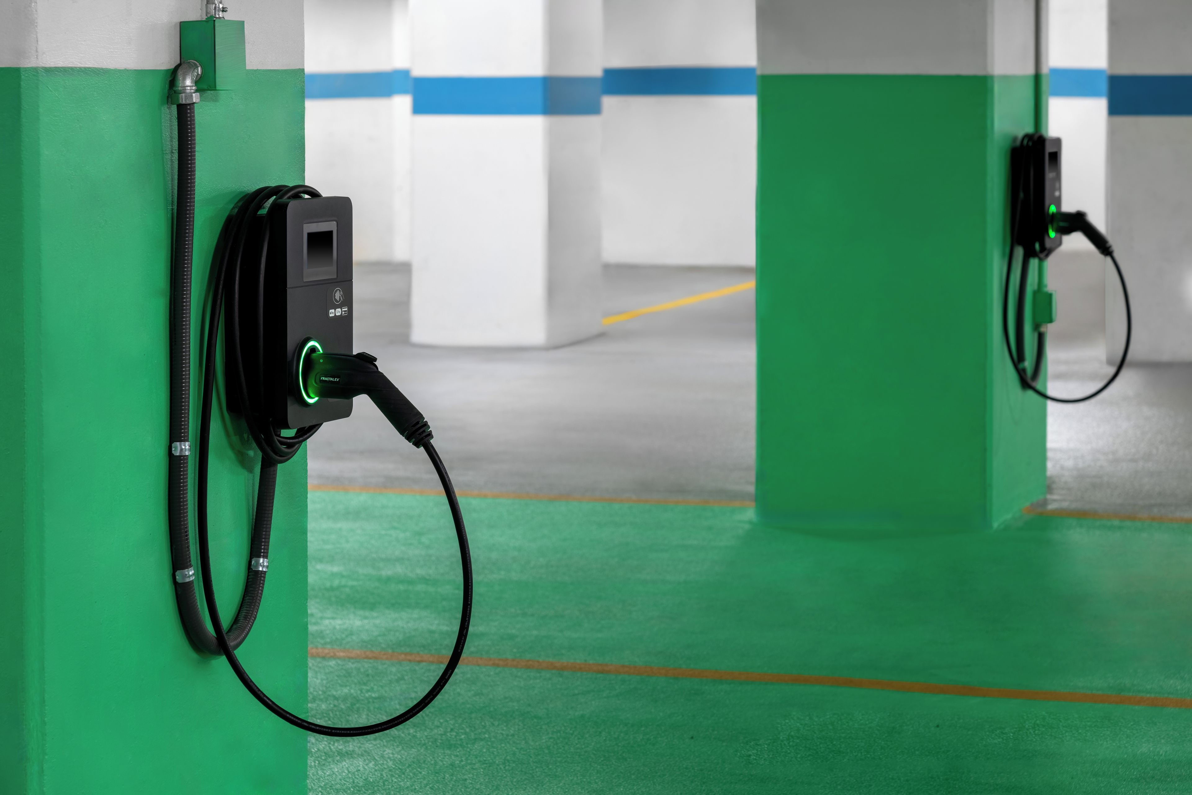 An electric vehicle charging station with a cable connected to a vehicle.