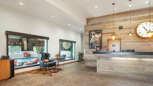 A spacious lobby with a reception desk, large windows, and a brick floor. - Best Western Prineville Inn (Prineville)