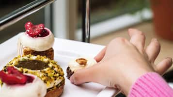 A tray with various pastries on a table near a window.
