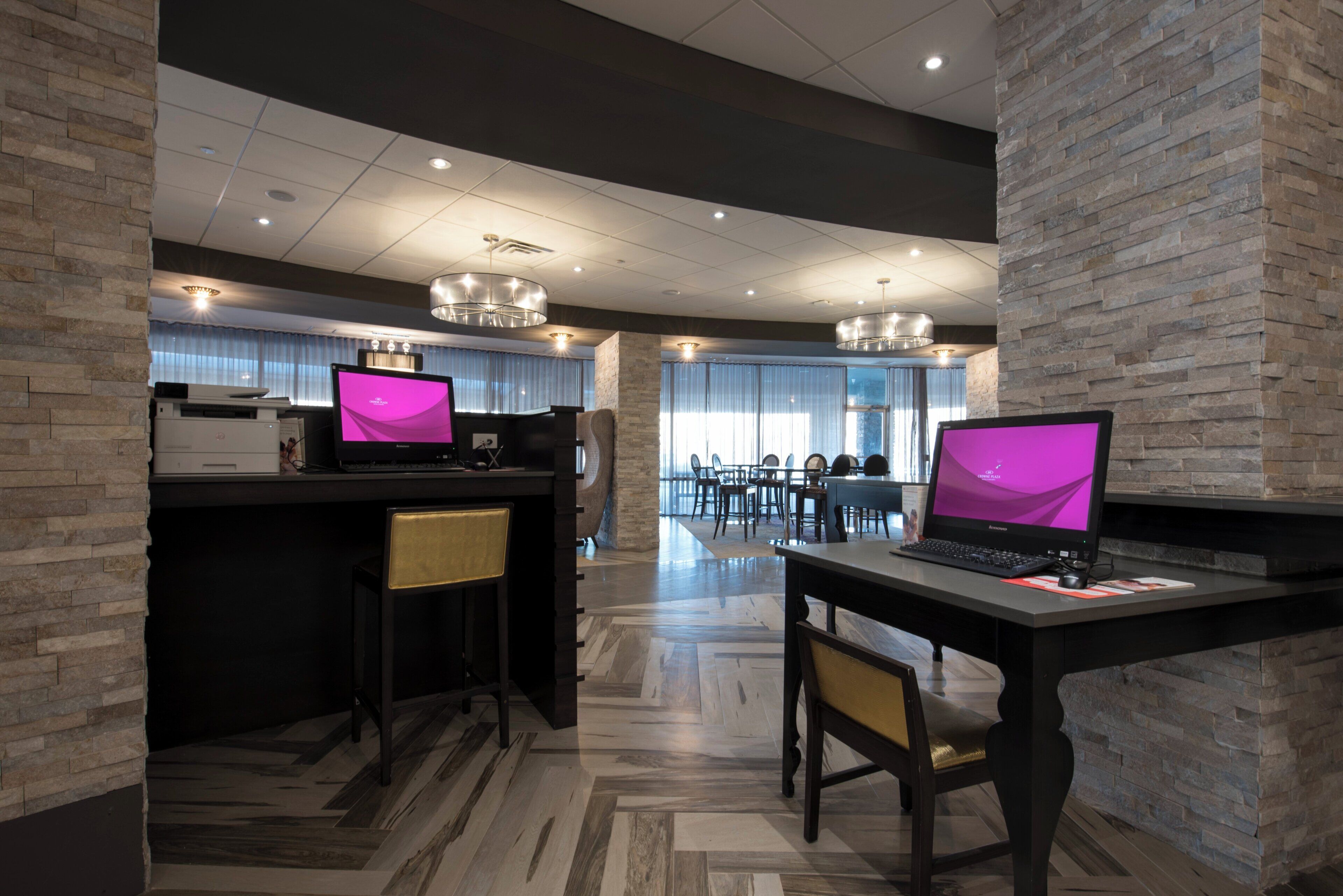 A modern office space with two desks, chairs, and a large window.