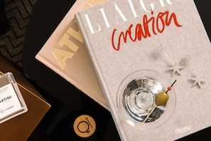 A book titled 'Liaison Creation' with a martini glass and starfish decoration on a table.