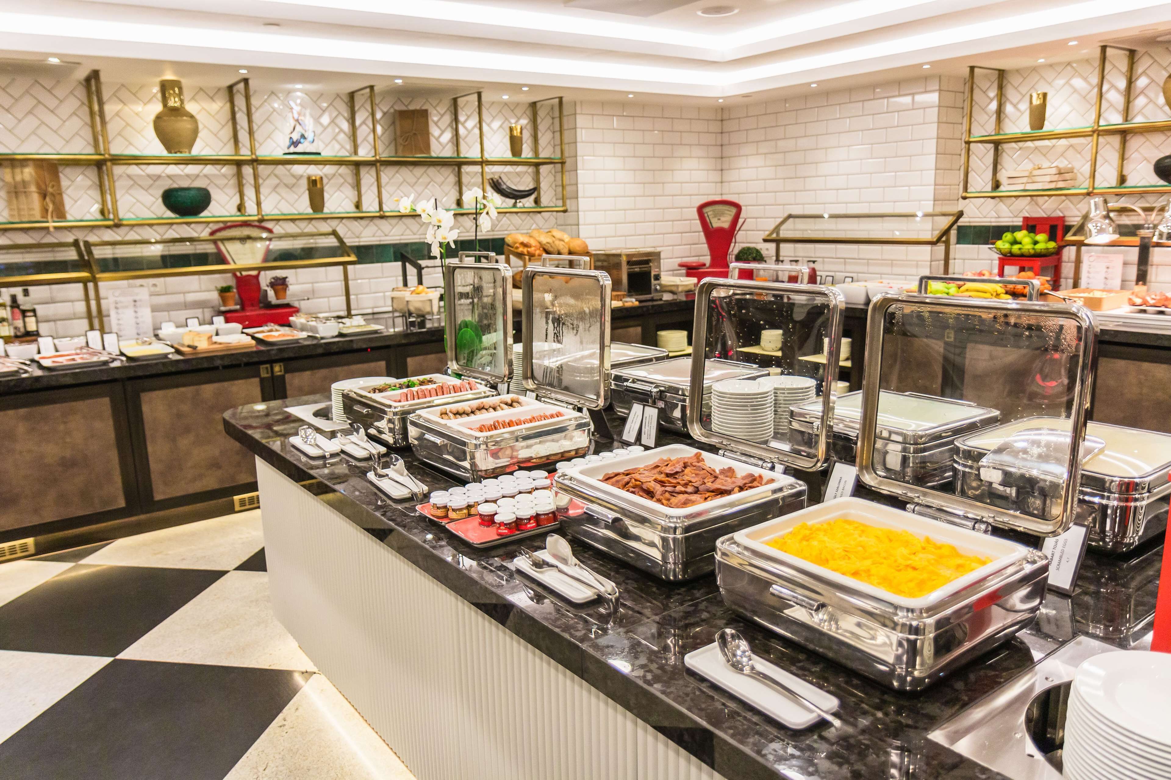 A buffet with various food items and a modern interior design.