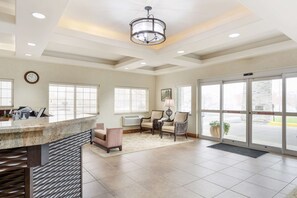 A spacious lobby with a reception desk, seating area, and large glass doors leading outside. - Best Western Plus Walla Walla Suites Inn (Walla Walla)