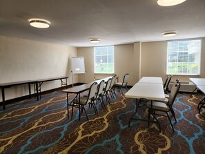 A conference room with tables, chairs, a whiteboard, and patterned carpet. - Red Roof Inn Knoxville Central - Papermill Road (Knoxville)
