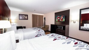 A hotel room with two beds, a desk, a chair, a television, and a mirror. - Red Roof Inn Knoxville Central - Papermill Road (Knoxville)