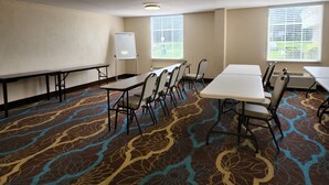 A conference room with a whiteboard, tables, chairs, and patterned carpet. - Red Roof Inn Knoxville Central - Papermill Road (Knoxville)