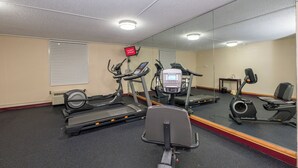 A gym with treadmills, an elliptical, and a stationary bike. - Red Roof Inn Knoxville Central - Papermill Road (Knoxville)