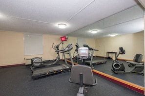 A gym with treadmills, an elliptical, and a stationary bike.