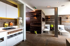 A modern hotel lobby with a reception desk, seating area, and a decorative plant.