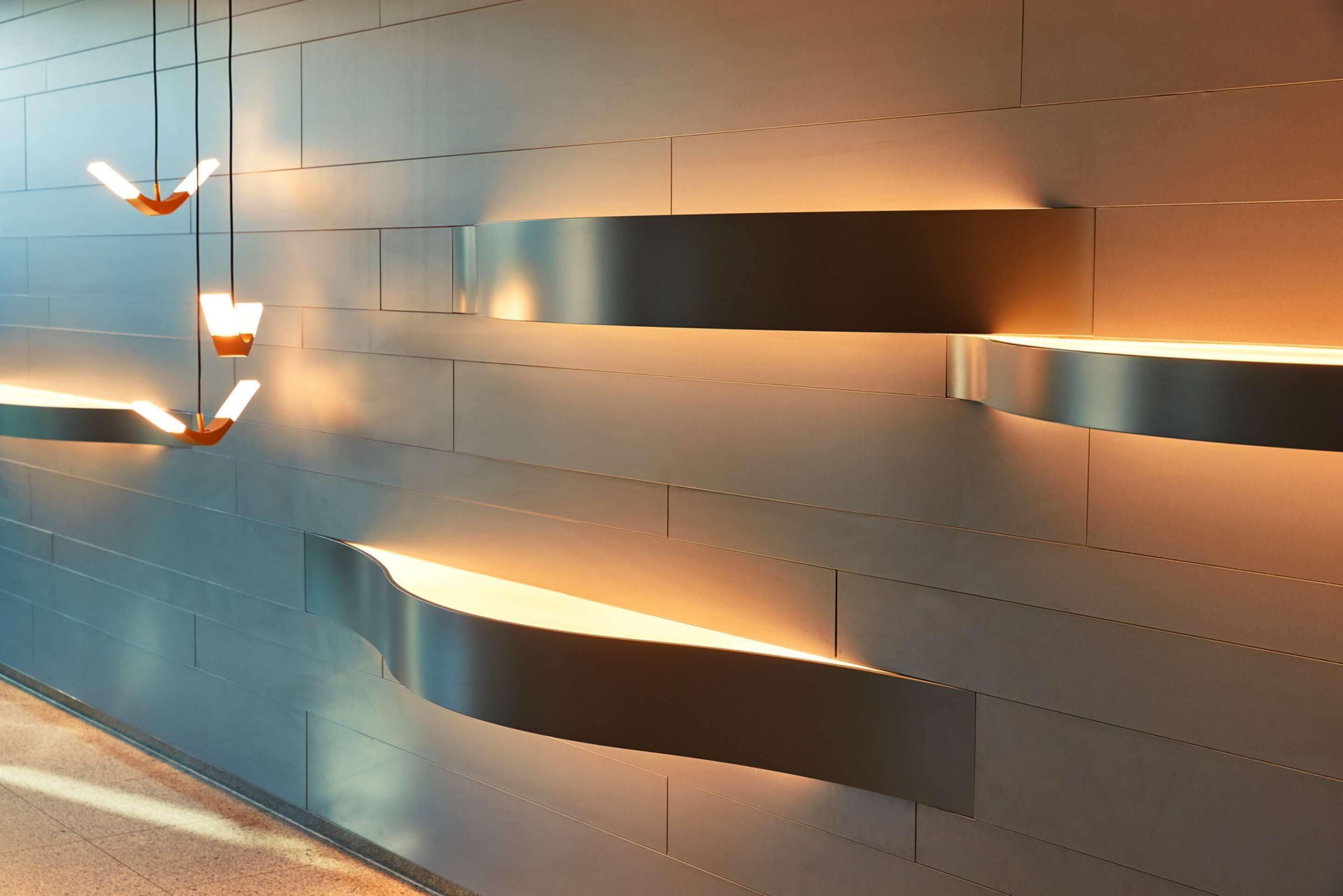 A modern wall with built-in lighting fixtures.