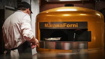 Una persona abriendo un horno Marana Forni.