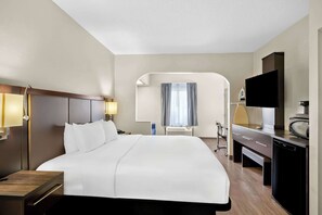 Relax in a spacious room with a large bed, flat-screen TV, and kitchenette.