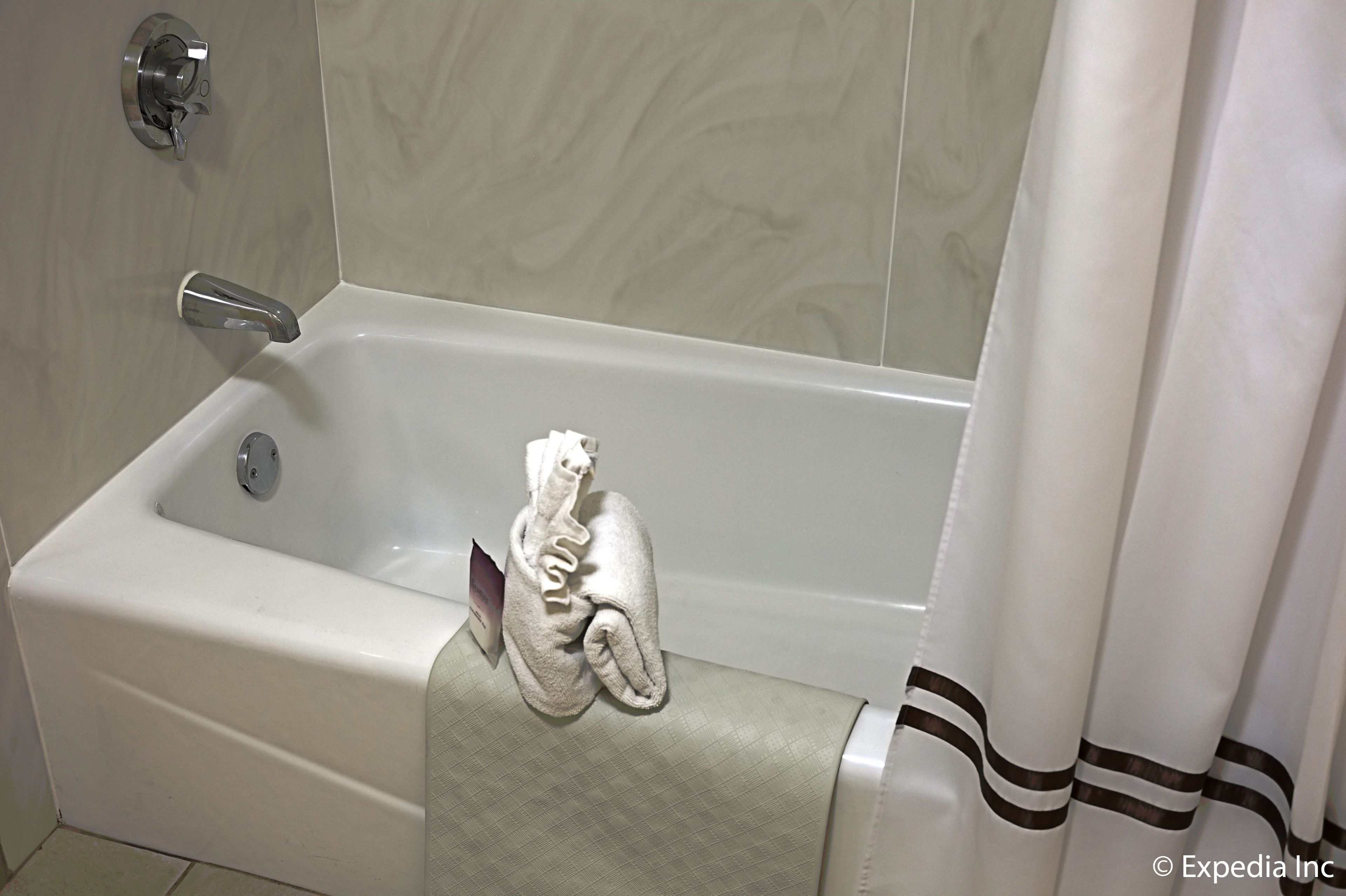 king with single sofa chair | bathroom | combined shower/bathtub, eco-friendly toiletries, hair dryer, towels