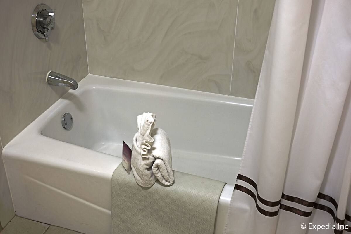 king with single sofa chair | bathroom | combined shower/bathtub, eco-friendly toiletries, hair dryer, towels