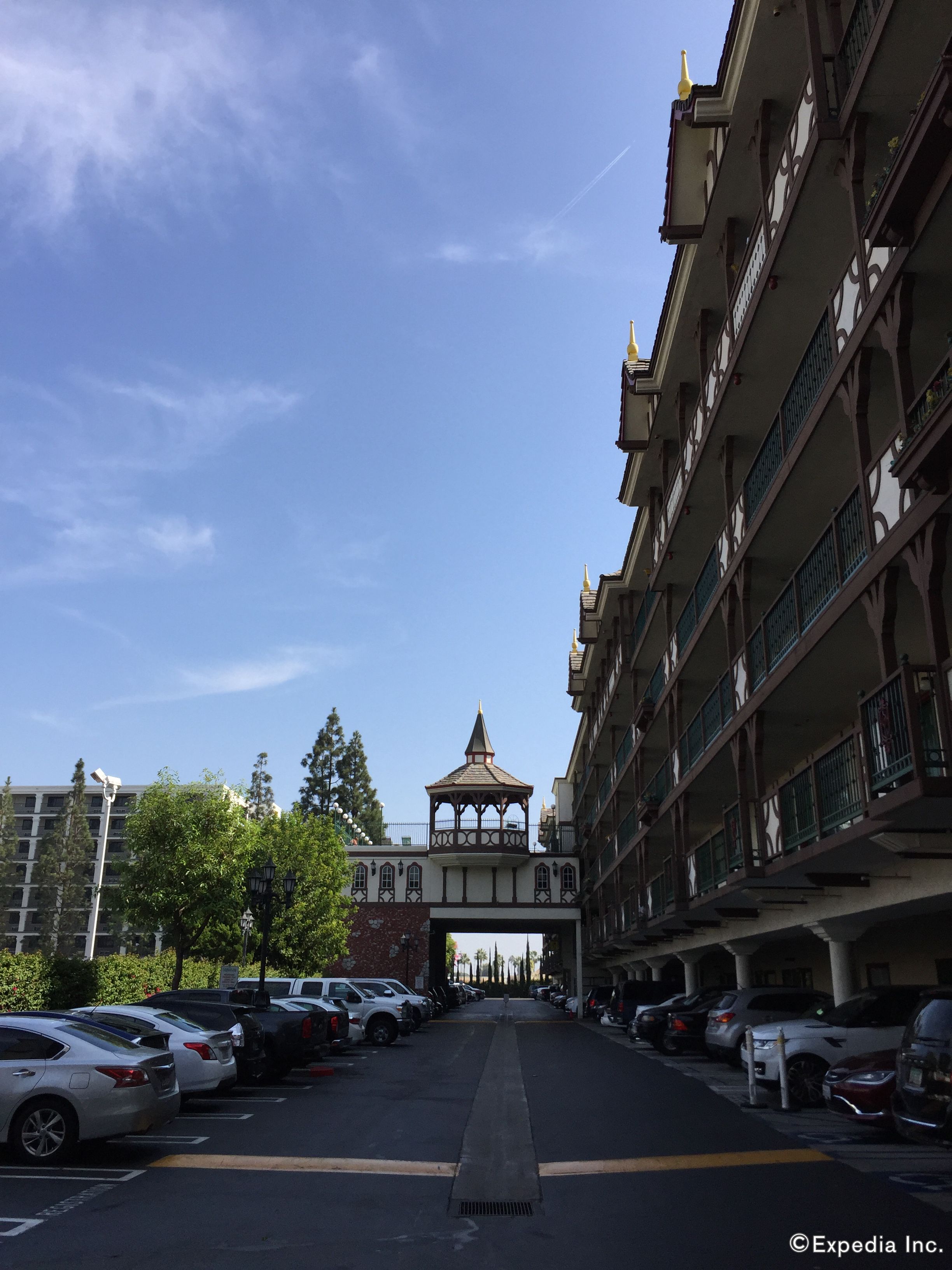 A multi-story building with a central tower and a covered walkway.