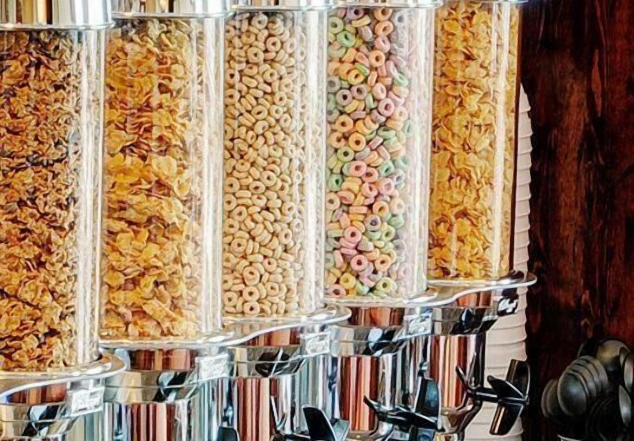 Un dispensador de cereales con compartimentos múltiples que contienen diferentes tipos de cereal.