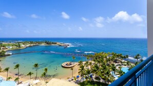 A coastal resort with a beach, palm trees, and a view of the ocean. - Caribe Hilton (San Juan)