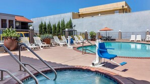 A swimming pool with lounge chairs and a lifeguard stand. - The Hills Inn Eagle Rock - Near Old Town Pasadena (Los Angeles)