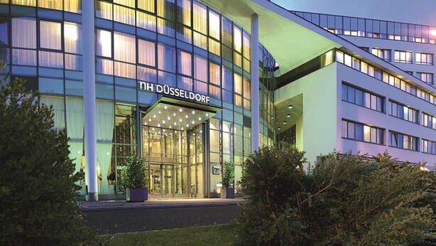 A modern hotel building with a curved facade, large glass windows, and a prominent entrance with a canopy. - NH Düsseldorf City (Düsseldorf)