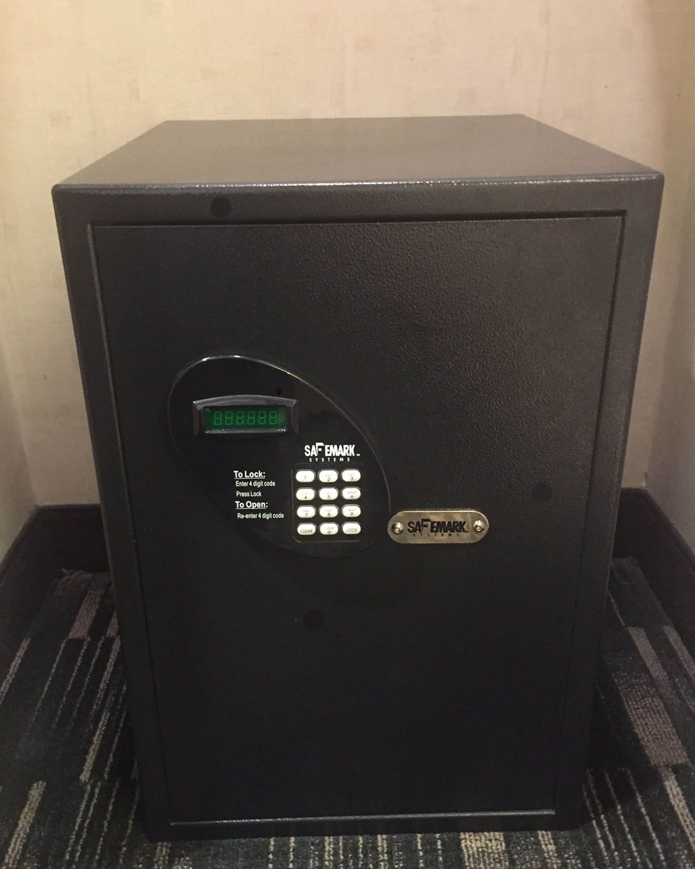 A black safe with a digital lock displaying '8888888'. Instructions for locking and unlocking are visible.