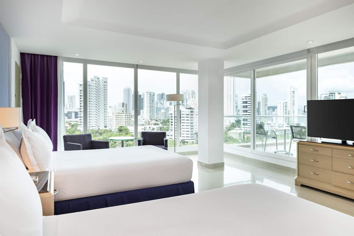 Room, 2 Queen Beds, Corner | Living area | 49-inch LCD TV with cable channels, TV, MP3 dock