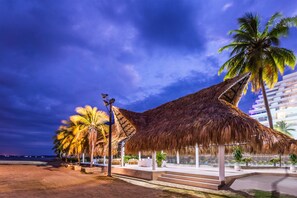Beach nearby, black sand, sun loungers, beach umbrellas