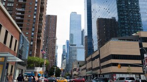 A city street with tall buildings, including a mix of modern and older architecture. - Travel Inn Hotel (New York)