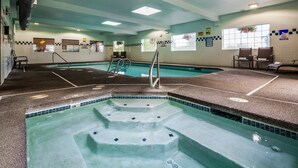 An indoor swimming pool with clear water, tiled steps, and safety signs. - Best Western Oak Meadows Inn (St. Helens)