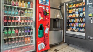 A vending machine with a variety of snacks and a drink dispenser. - Red Roof Inn West Monroe (West Monroe)