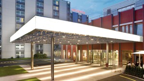 A modern hotel entrance with a covered walkway, glass doors, and a visible "MÖVENPICK" sign. - Mövenpick Hotel Zuerich-Airport (Opfikon)