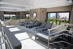 Indoor pool, open 9:00 AM to 9:00 PM, pool loungers, lifeguards on site