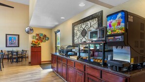 A kitchen area with a long counter, a microwave, a coffee machine, and a refrigerator. - Best Western Benton Inn (Benton)