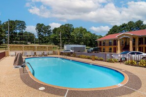 Enjoy a refreshing swim in the pool surrounded by a pebble-textured deck and a low, tiled edge.
