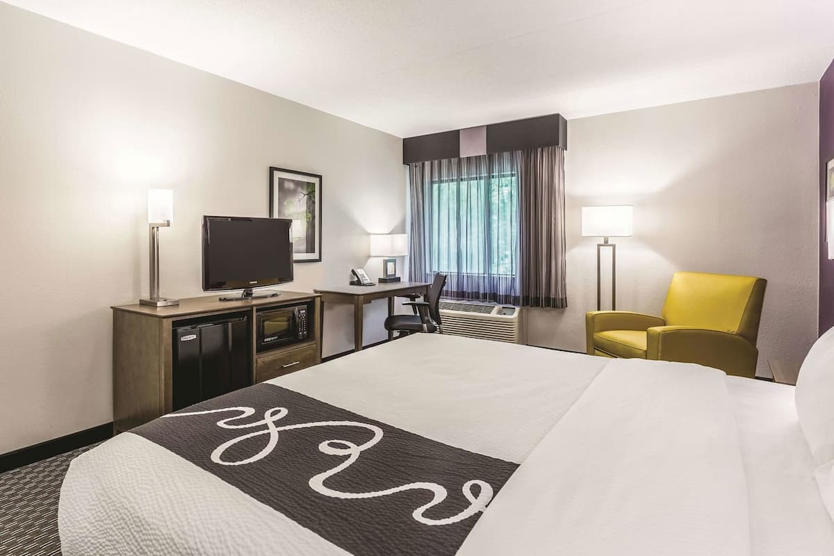 Premium bedding, desk, laptop workspace, blackout curtains