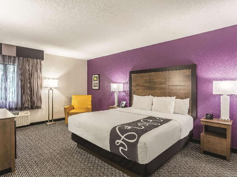 Premium bedding, desk, laptop workspace, blackout drapes