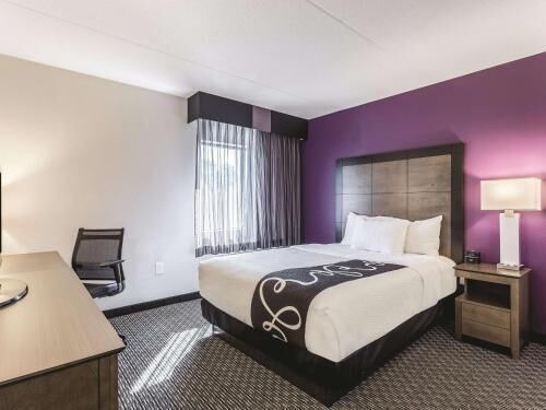 Premium bedding, desk, laptop workspace, blackout drapes