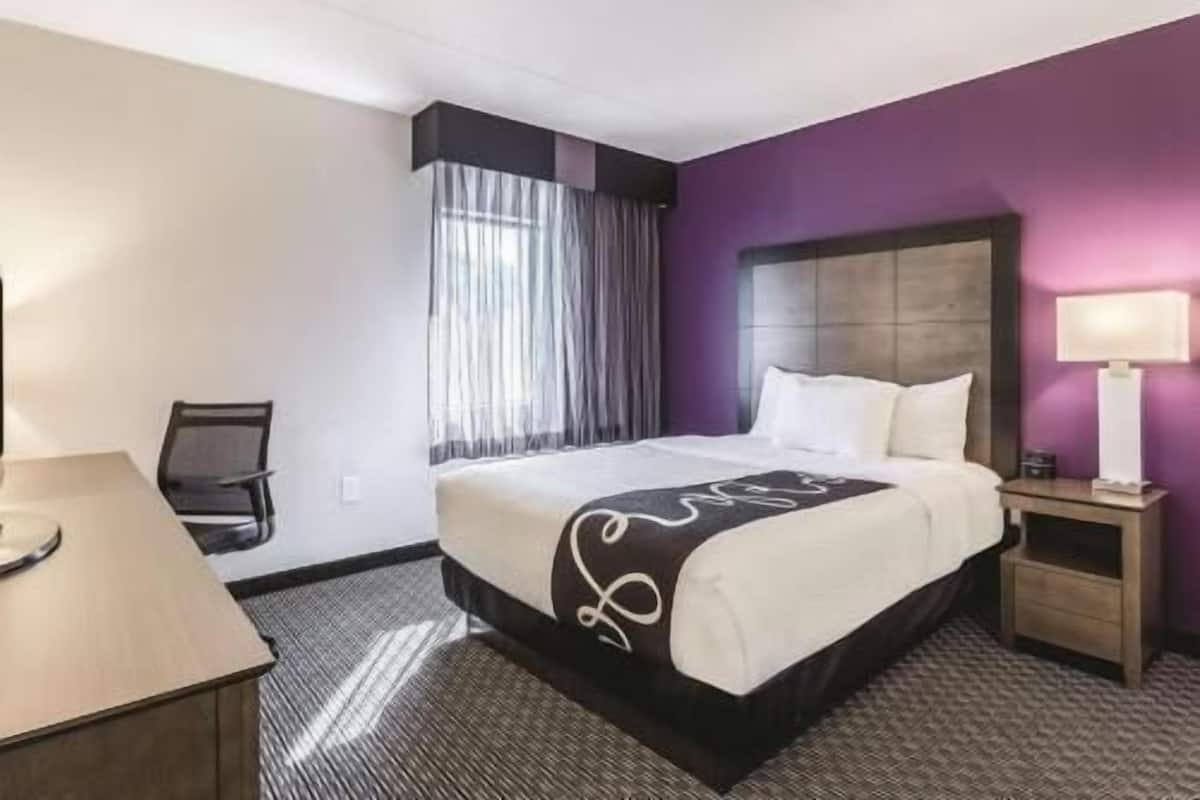 Premium bedding, desk, laptop workspace, blackout curtains