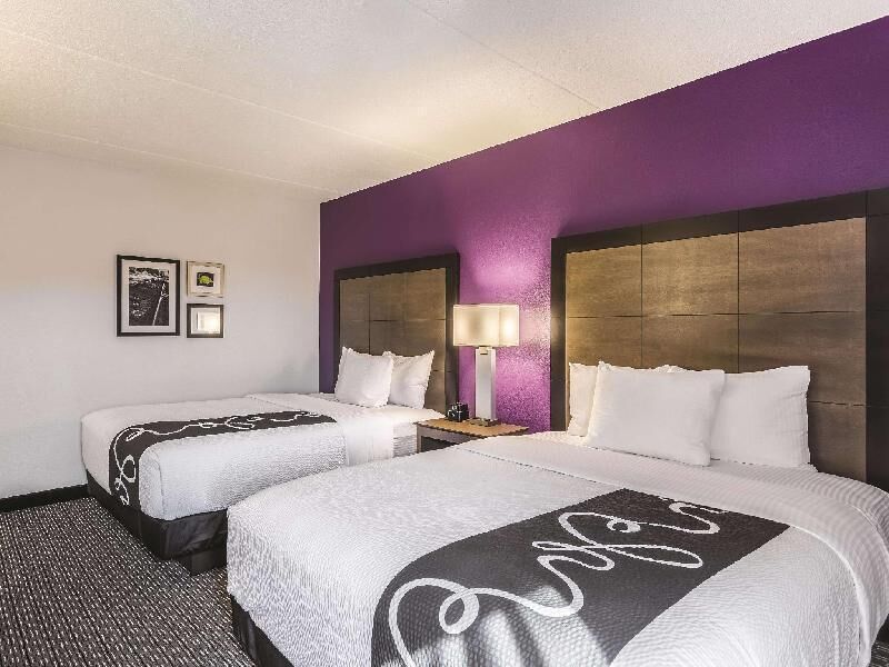 Premium bedding, desk, laptop workspace, blackout drapes
