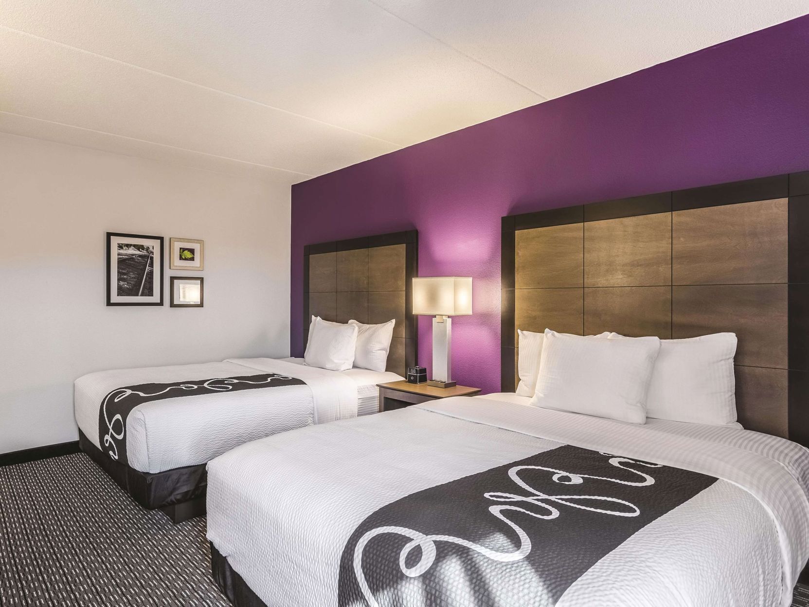 Premium bedding, desk, laptop workspace, blackout drapes