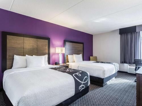 Premium bedding, desk, laptop workspace, blackout drapes