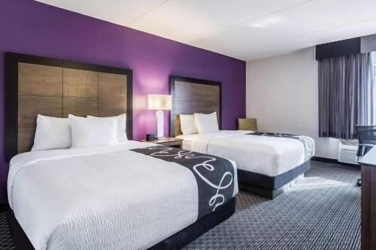 Premium bedding, desk, laptop workspace, blackout curtains