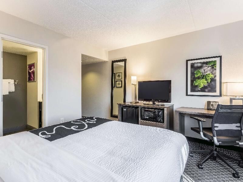 Premium bedding, desk, laptop workspace, blackout drapes