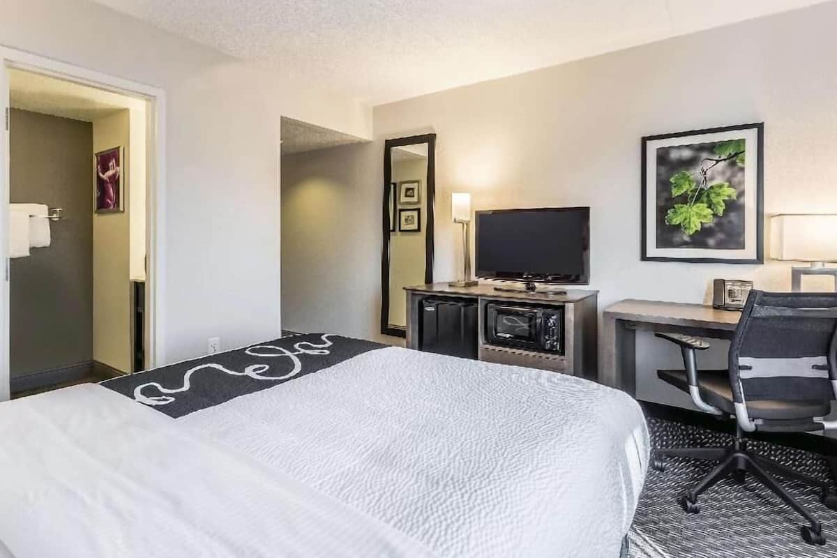 Premium bedding, desk, laptop workspace, blackout curtains