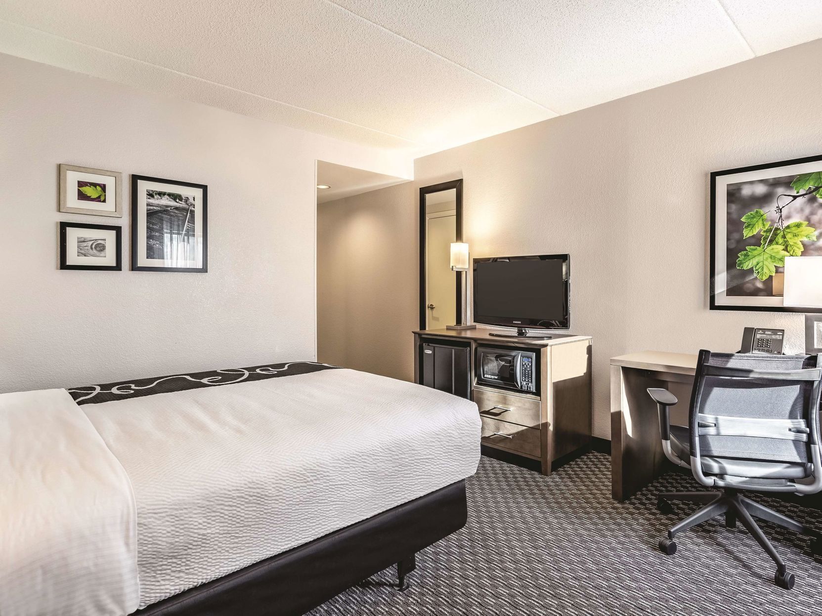 Premium bedding, desk, laptop workspace, blackout drapes