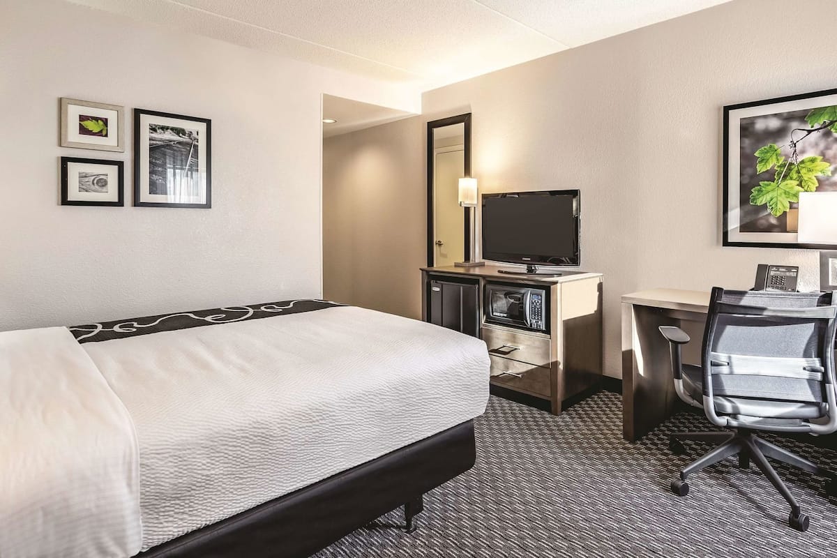 Premium bedding, desk, laptop workspace, blackout curtains
