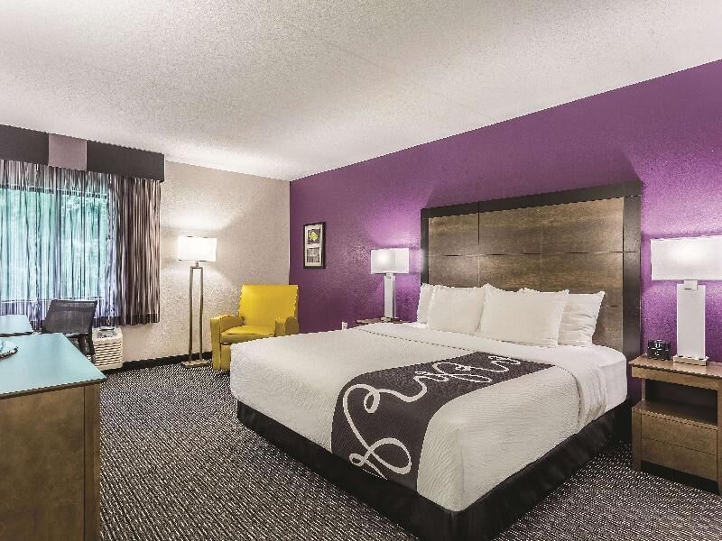 Premium bedding, desk, laptop workspace, blackout drapes
