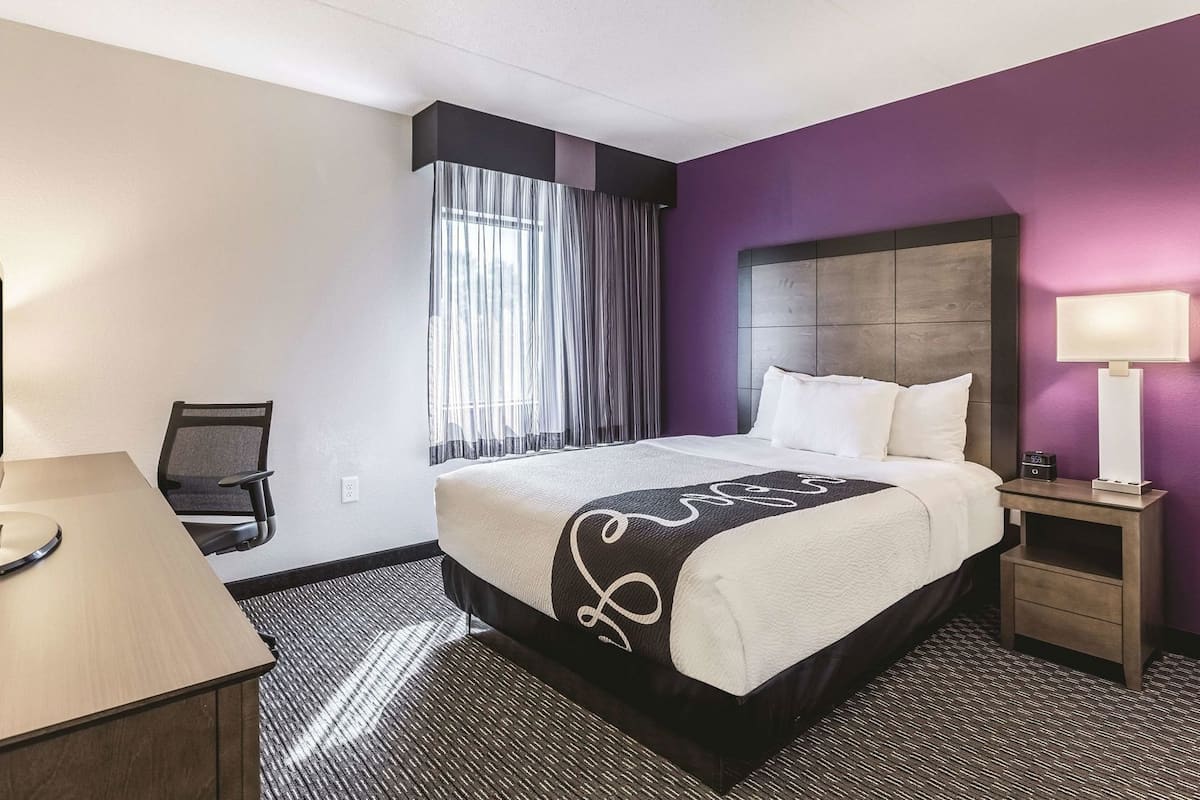 Premium bedding, desk, laptop workspace, blackout curtains