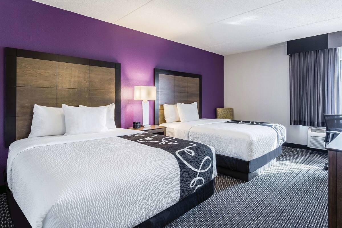 Premium bedding, desk, laptop workspace, blackout curtains