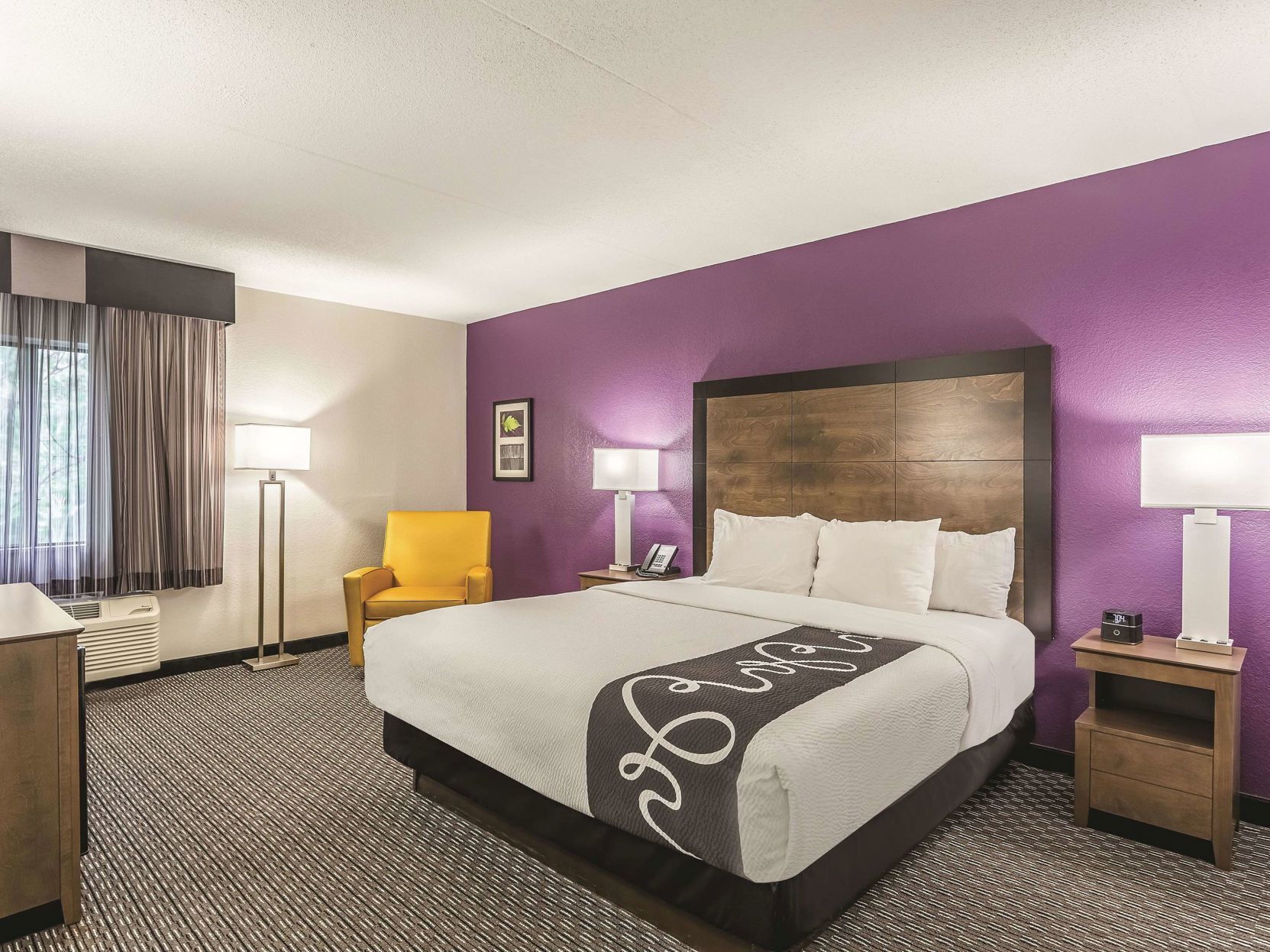 Premium bedding, desk, laptop workspace, blackout drapes