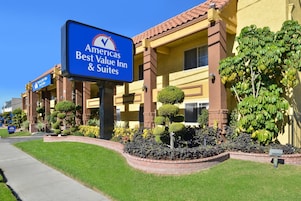 A hotel with a prominent sign for 'Americas Best Value Inn & Suites'.
